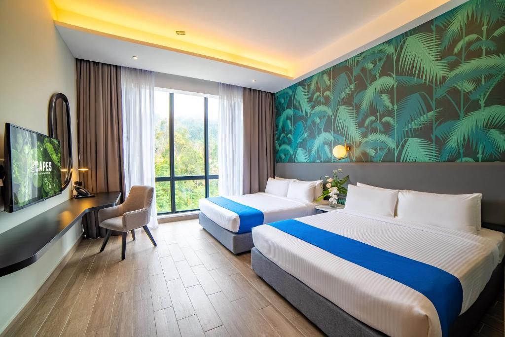 A hotel room with two beds, a desk, a TV, and a large window with a view.