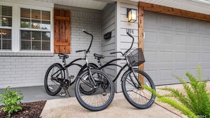 A residential garage with two bicycles parked outside. - the ORANGE DOOR just steps from art, trails & dining (Bentonville)