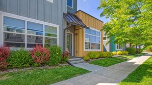 A modern building with large windows, a well-maintained lawn, and a clear pathway leading to the entrance. - Wonderful Three Bedroom Townhome in Old Town North (Fort Collins)