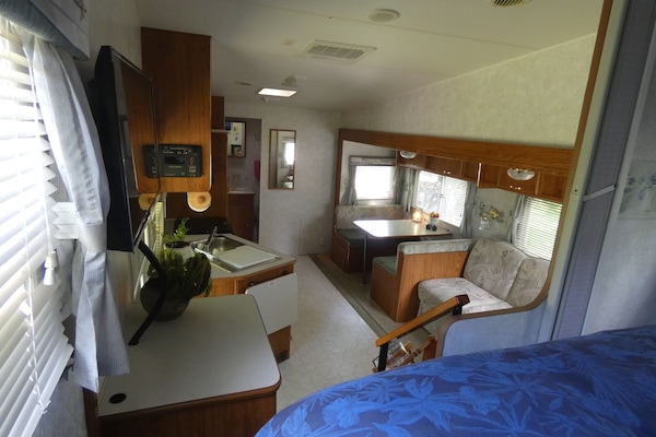 entry door on left side, main space, bathroom far end, bedroom near end
