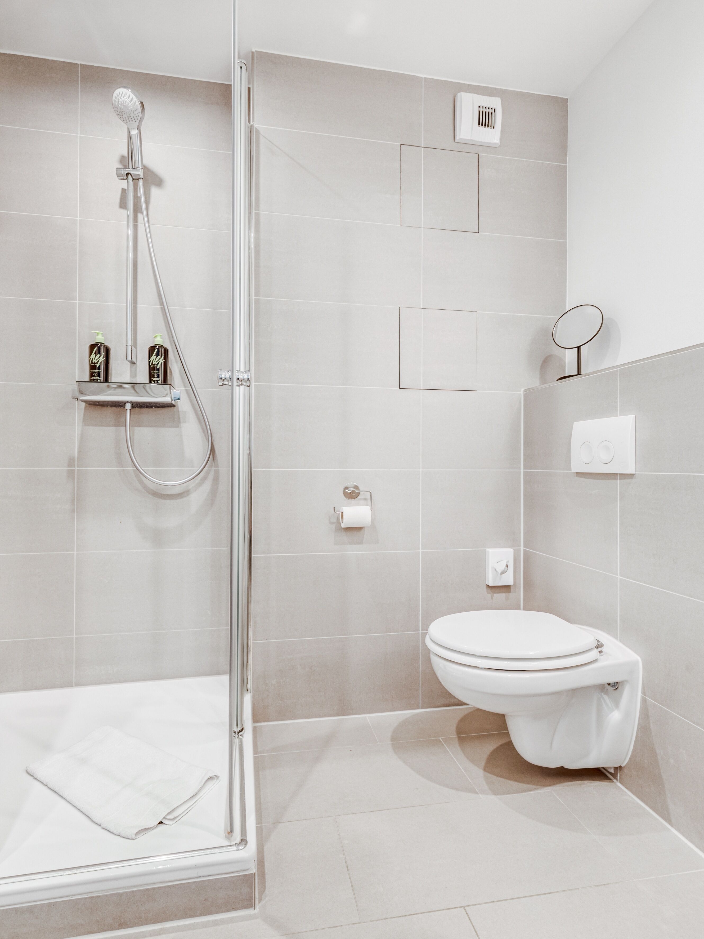 Suite M | Bathroom | Shower, hair dryer, towels, toilet paper