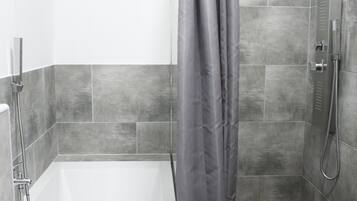 Bathtub, hair dryer, towels, soap
