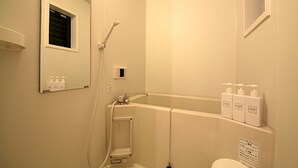 A bathroom with a bathtub, a shower, a toilet, and a window. - Kyo Maimai (Kyoto)