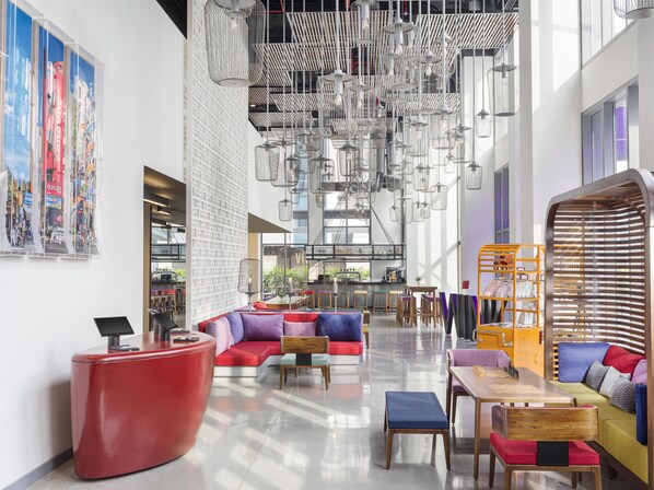 A modern interior with seating areas, a bar, and a large window.