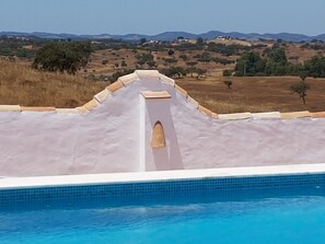 Una piscina al aire libre, tumbonas