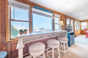 Relax in a peaceful room with a large window view, a long bar counter, and a comfortable seating area.