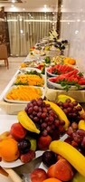 A buffet table with various fruits and vegetables.