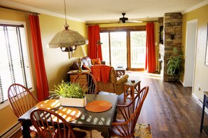 A dining area with a table set for four, surrounded by wooden chairs. - Overlook at Southcrest condo (Beech Mountain)