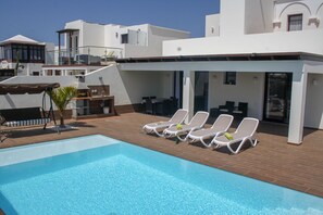 A pool area with lounge chairs and a barbecue setup. - 3-Bedroom Anti-Stress Villa with Private Pool (Yaiza)