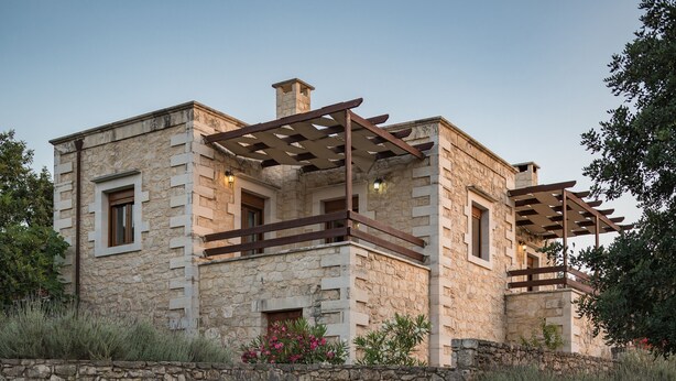 A stone building with a balcony, a chimney, and a stone wall. - Koules Estate-Anemone, with Pool & BBQ, an Agricultural barn for Nature lovers (Rethymno)