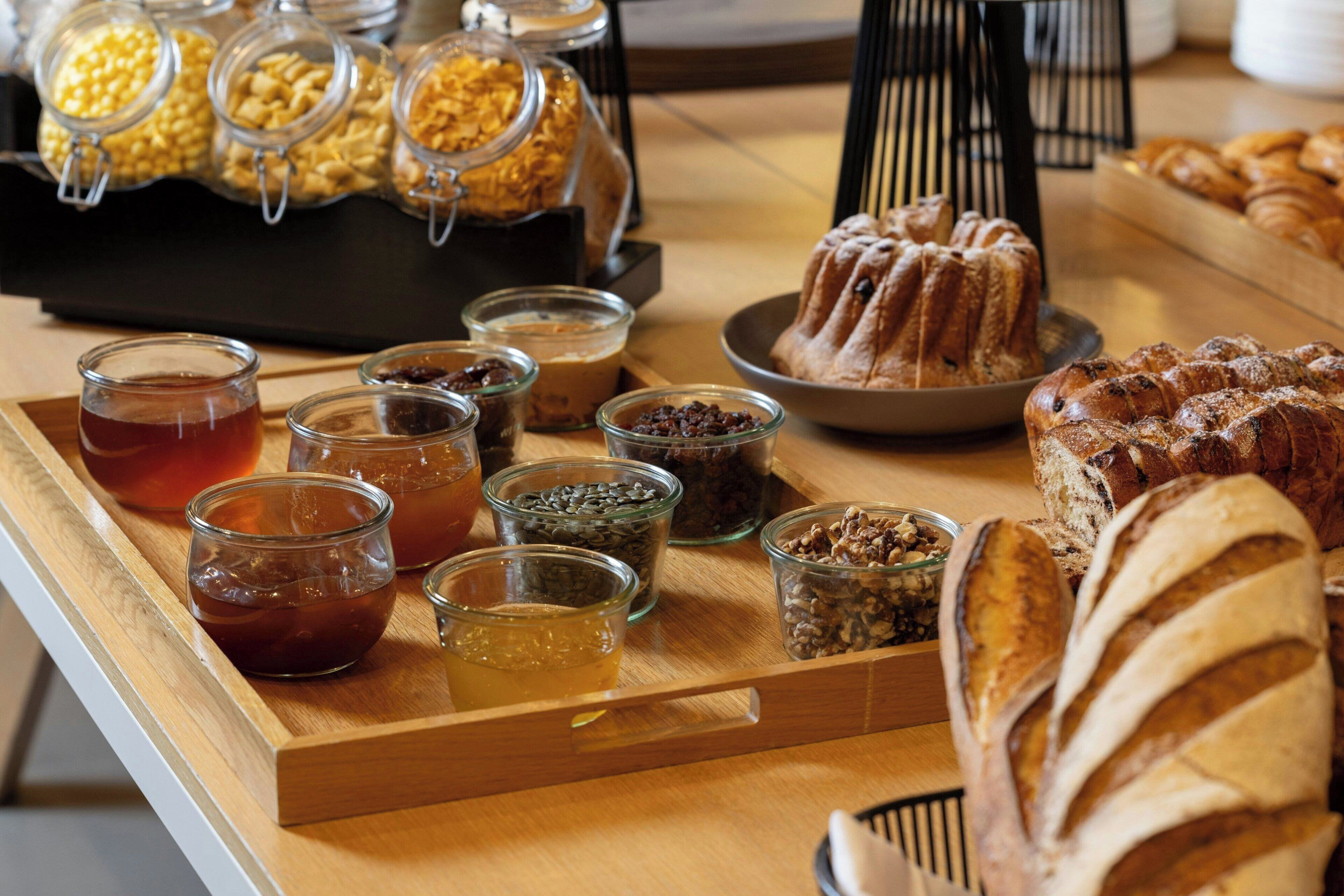 A breakfast buffet with various food items and condiments.