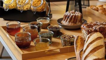 A breakfast buffet with various food items and condiments.