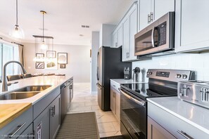 Enjoy cooking in this well-equipped kitchen with stainless steel appliances and ample counter space.
