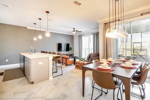 Enjoy a spacious living area with a dining table for six, a central island, and an oven.