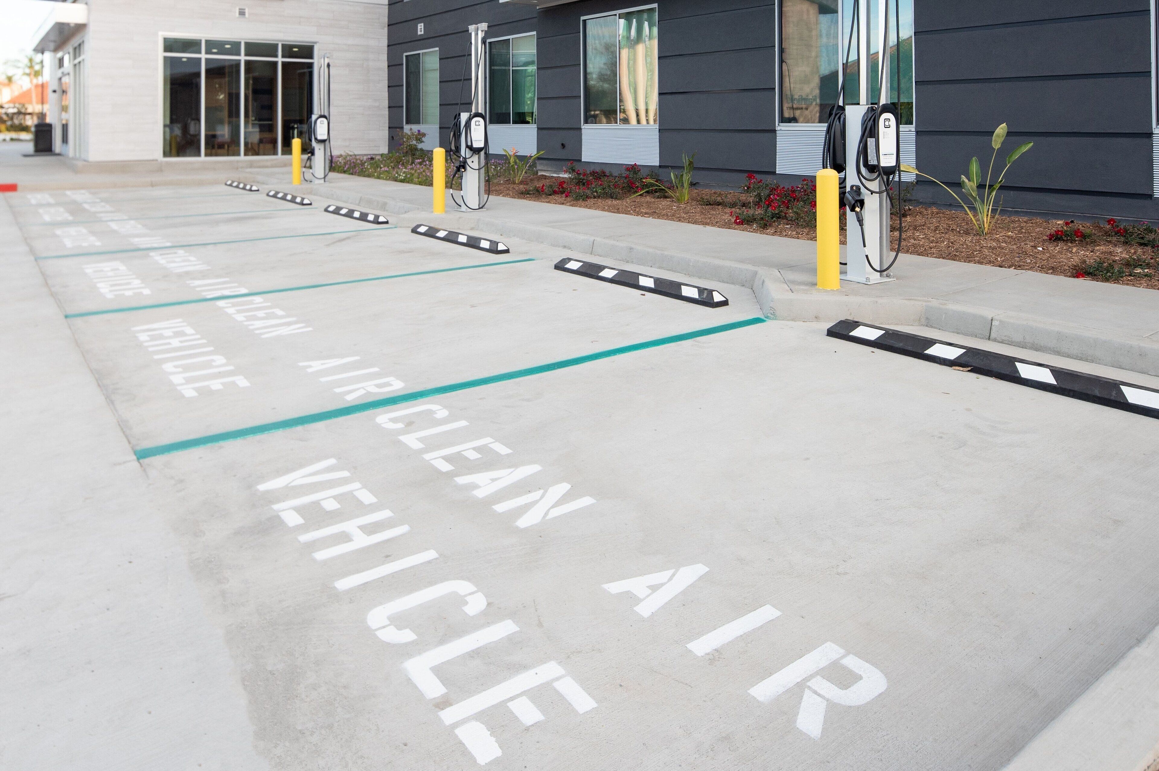 A parking area marked for clean air vehicles with charging stations.