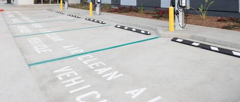 A parking area marked for clean air vehicles with charging stations.