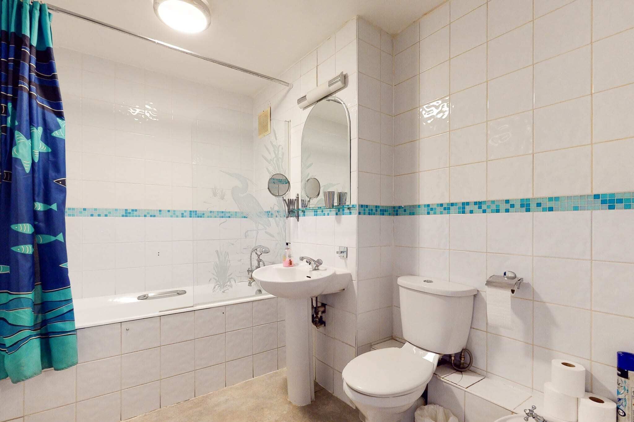 A bathroom with a bathtub, sink, and toilet.