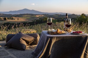 A table set outdoors with a view of rolling hills and mountains in the background. - Authentic Tuscan Villa with infinity pool & stunning views of Val d'Orcia (Montefollonico)