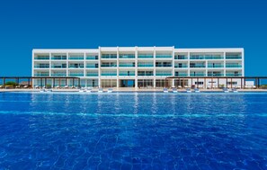 Relax by the pool with lounge chairs and umbrellas.