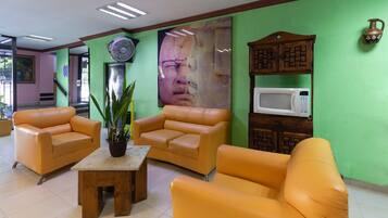 Standard Room (Three beds) | Living room | 21-inch TV with cable channels