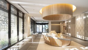 A modern reception area with a central seating area, a wooden ceiling feature, and a view through the entrance.