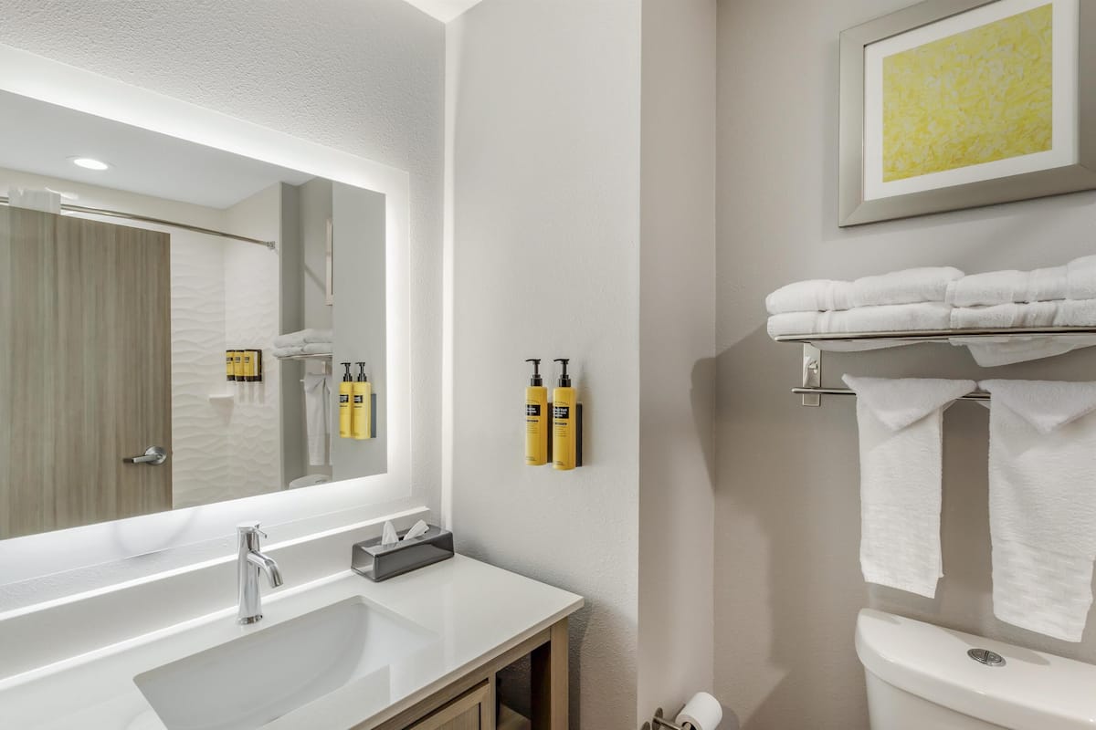 standard room, 2 queen beds, non smoking, refrigerator & microwave | bathroom | combined shower/bathtub, rainfall showerhead, free toiletries