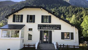 A two-story building with a sign reading "HOTEL BAR RESTAURANT CHIROULET".