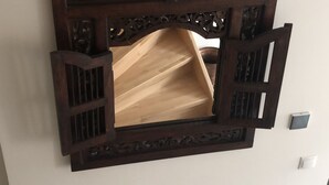 A wall-mounted wooden cabinet with intricate carvings and a central open shelf. - Vacation with a view of the unique Marksburg Castle (Braubach)