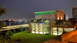 A modern building with a glass facade and a sign reading "Mukammar Ali Center". - Cassius Quarters@The713! Downtown, large, upscale suite w/private balcony (Louisville)