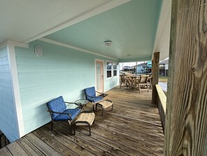 Relax in this serene outdoor space with a comfortable seating area featuring two chairs and a bench.