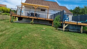 A two-story house with a balcony, a fenced deck, and a swimming pool. - Quiet country house (Triguères)