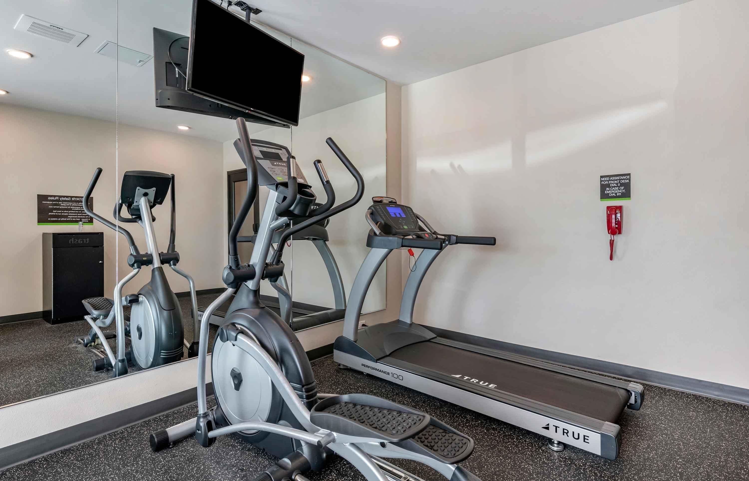 A fitness area with treadmills, an elliptical, and a stationary bike.