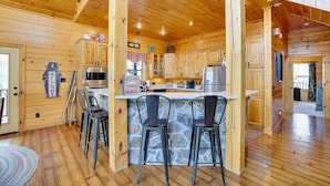 A wooden cabin with a stone island bar, wooden cabinets, and a bear-shaped welcome sign. - Spacious & Secluded Cabin: 25 Mi to Bentonville! (Sulphur Springs)