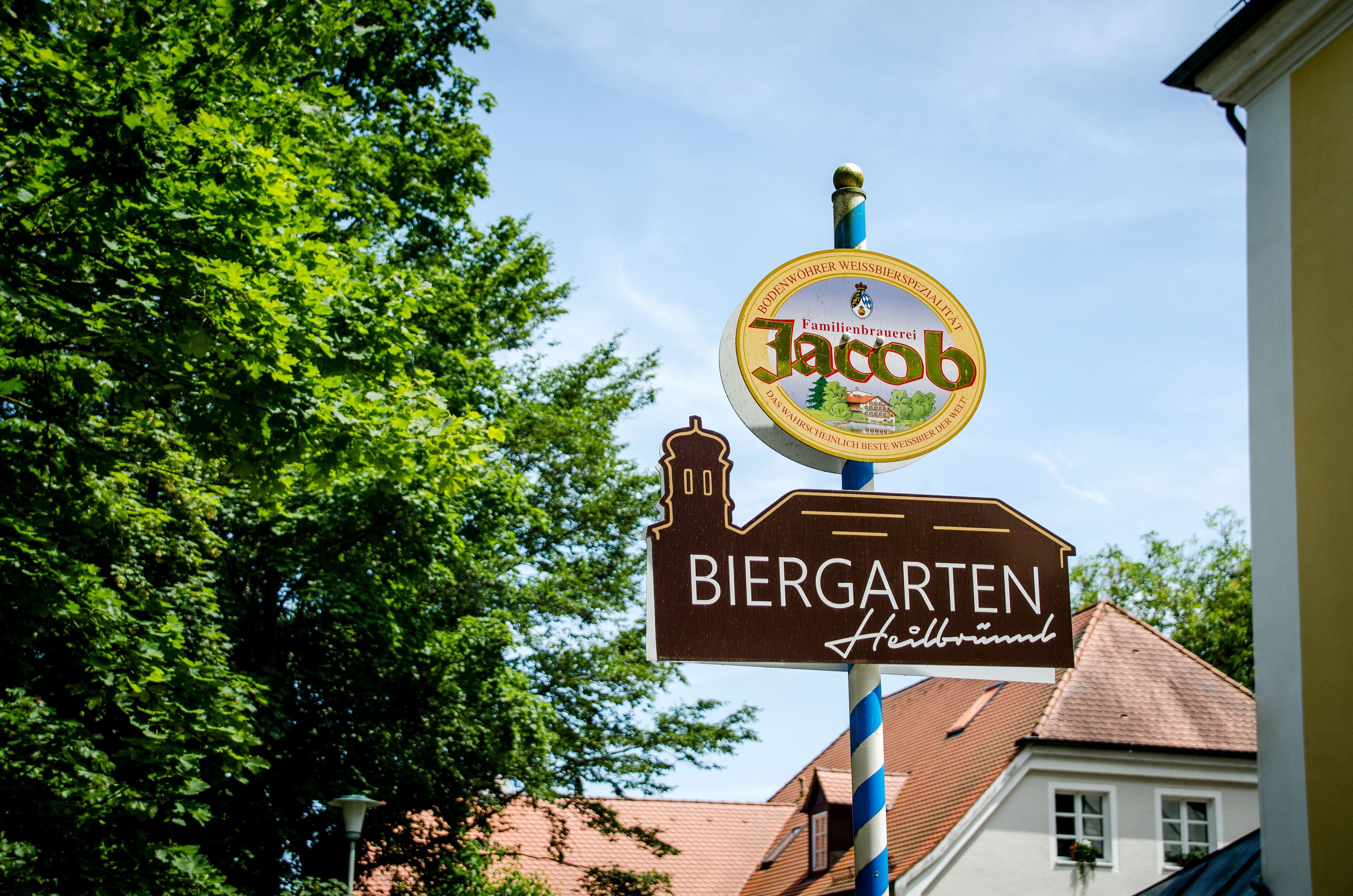 A sign for a beer garden with a logo and name.