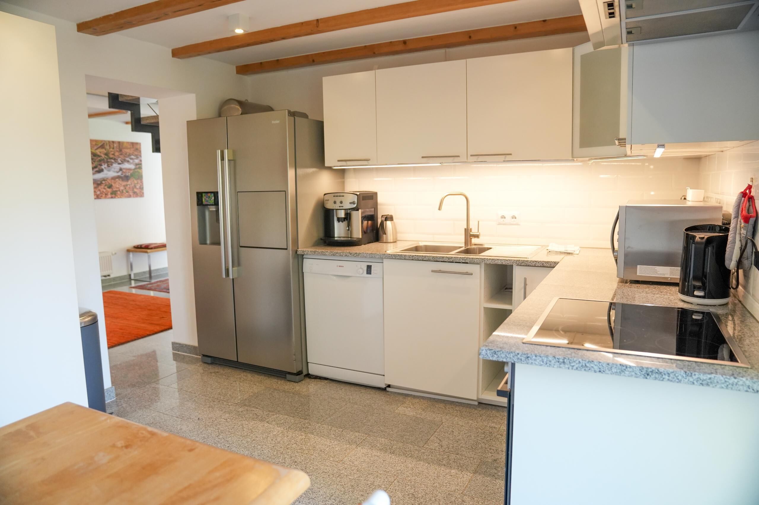 A modern kitchen with stainless steel appliances, a dishwasher, and a coffee maker.