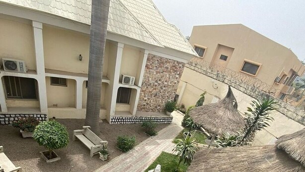 A building with multiple balconies, air conditioning units, and a mix of stone and plaster walls. - Haitel Guest Inn (Kano)