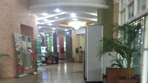 A spacious lobby with a polished marble floor, a reception desk, and a large potted plant. - Haitel Guest Inn (Kano)