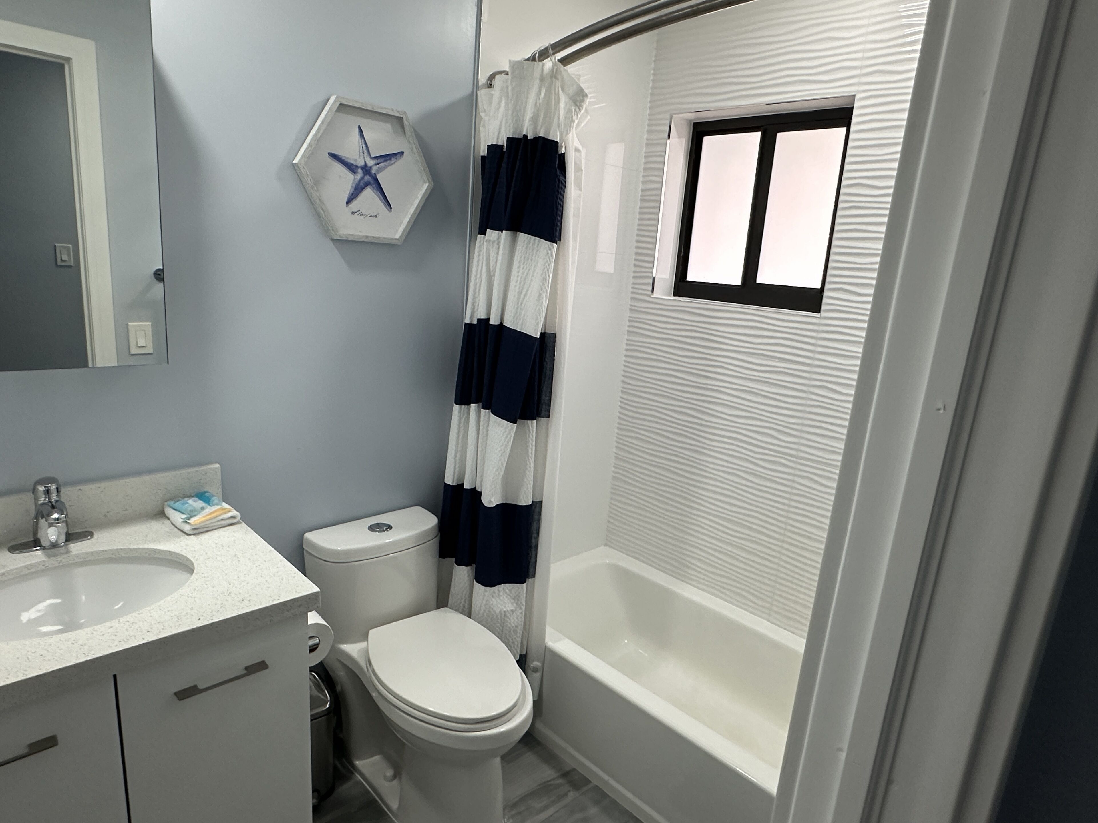 A bathroom with a toilet, sink, and bathtub.