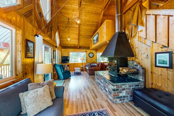 Cozy cabin-style living area with a sofa set, coffee table, and fireplace.