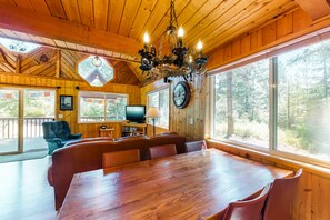 Enjoy meals with family and friends at the large dining table surrounded by comfortable seating.