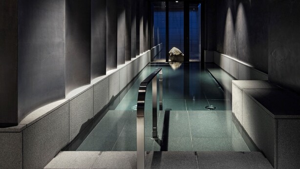 A modern, minimalist hallway with a glass-bottomed pool, leading to a blue-lit room. - Hotel tou nishinotoin kyoto (Kyoto)