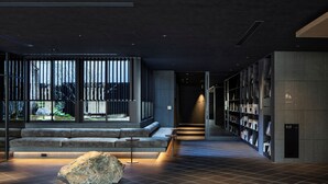 A modern interior with a seating area, bookshelves, and a view through large windows. - Hotel tou nishinotoin kyoto (Kyoto)
