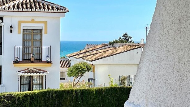 A coastal building with a balcony, a white facade, and a view of the sea. - RIVIERA PLAYA 200m to the beach in Riviera del Sol (Mijas Costa)
