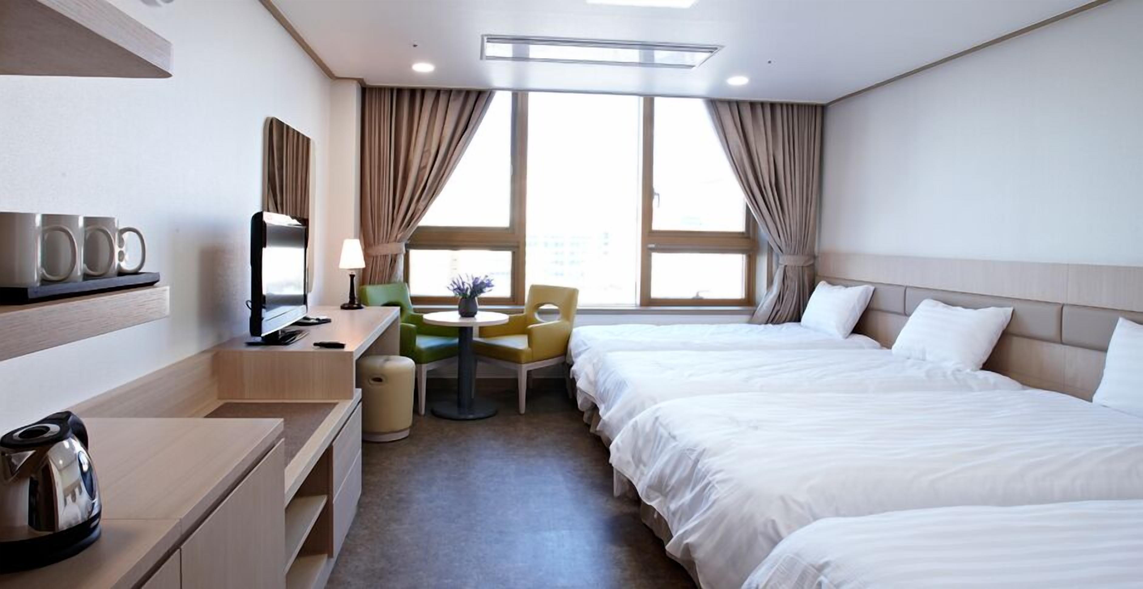 deluxe quadruple room | premium bedding, memory-foam beds, desk, laptop workspace