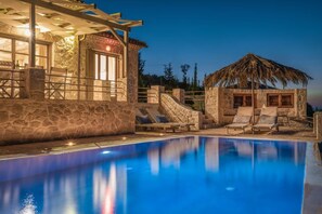 An infinity pool, sun loungers