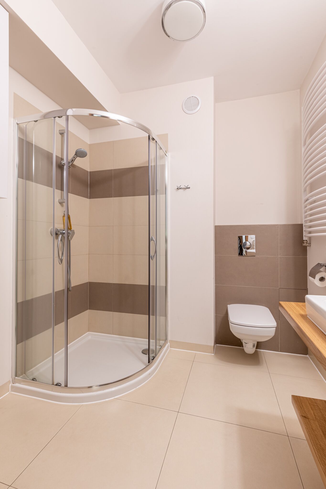 Une salle de bain moderne avec une douche à parois de verre, des toilettes et un lavabo.