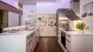 A modern kitchen with white cabinetry, stainless steel appliances, and a central island. - Holiday Apartment "Hof zum Stadl" 1 at Lake Constance – Walk to Ravensburger Spieleland (Meckenbeuren)