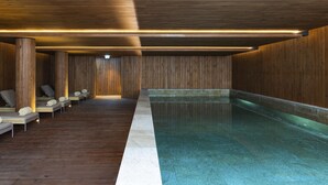 A spa area with wooden walls, a pool, and several lounge chairs. - Casa da Companhia Hotel & Spa, Vignette Collection by IHG (Porto)