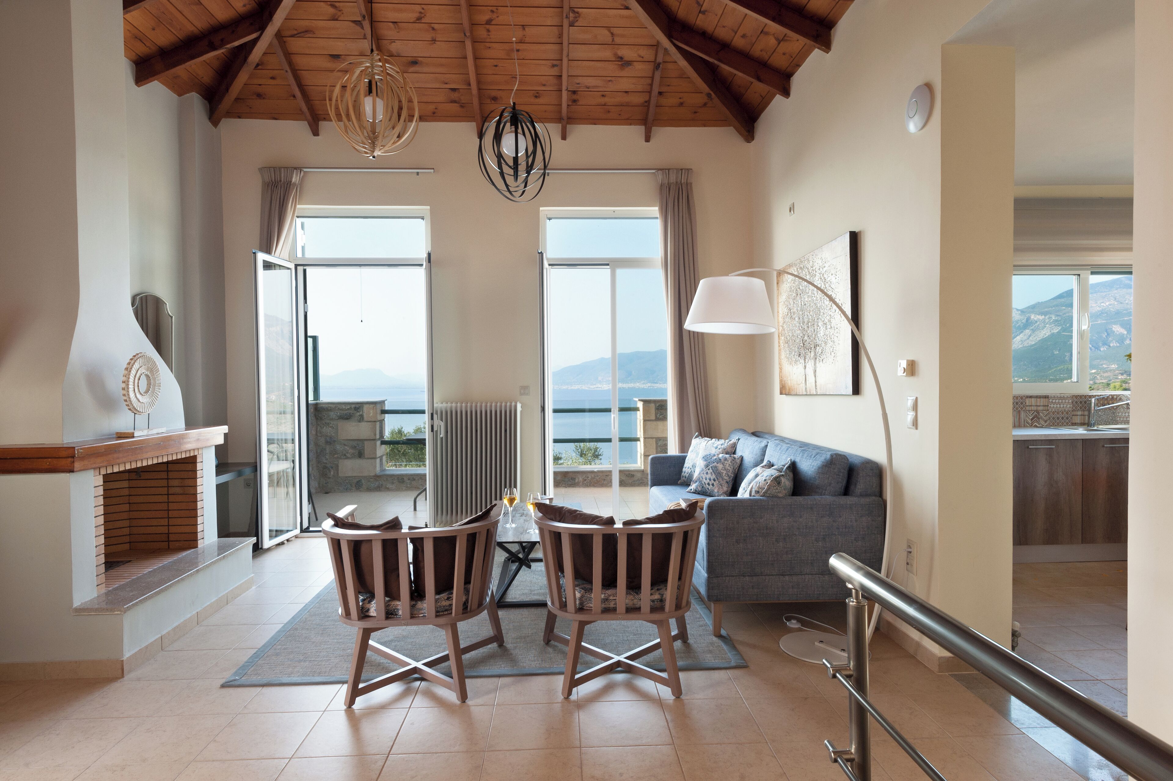 A spacious living area with a fireplace, a dining set, and a sofa.