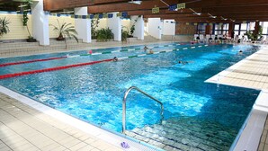 An indoor swimming pool with multiple lanes, tiled floors, and potted plants around the perimeter. - Wonderful apartment inside the top residence kurz (Maso Corto)